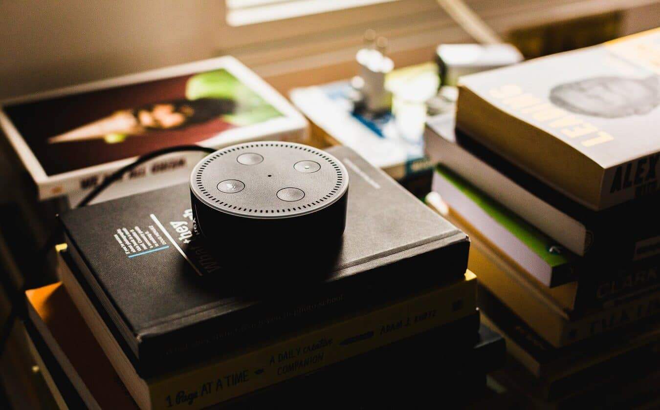 amazon echo sitting on a stack of books