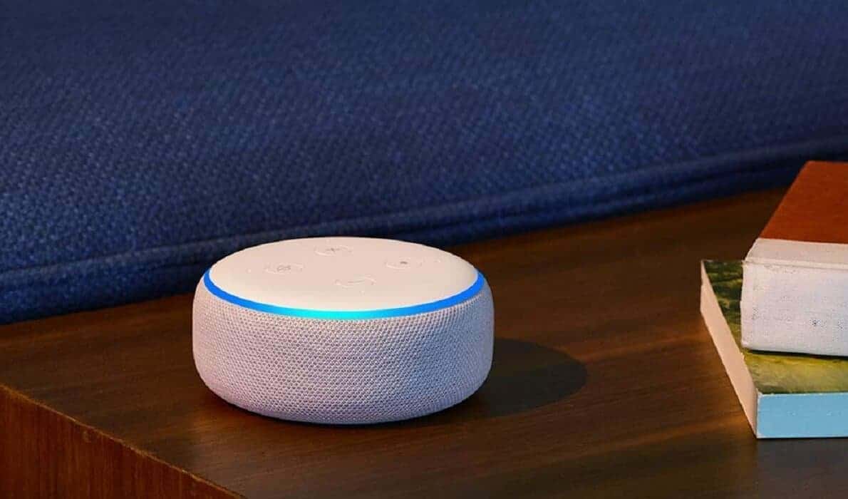 An amazon echo dot device with alexa against a blue background