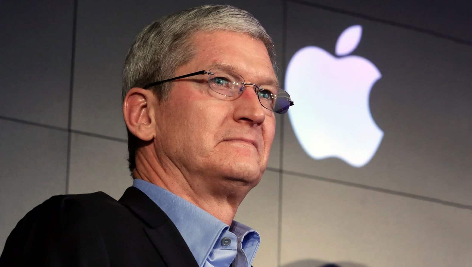 Apple's tim cook standing with an apple logo behind him