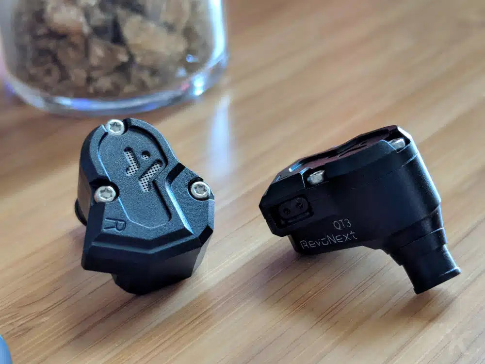 revonext qt3 earbuds on desk