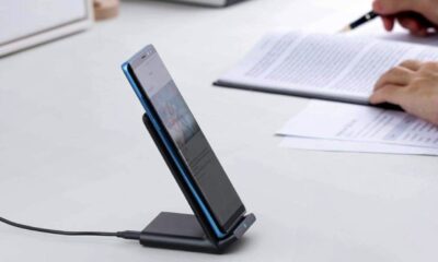 Anker charging stand on a desk near writing papers