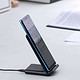 Anker charging stand on a desk near writing papers