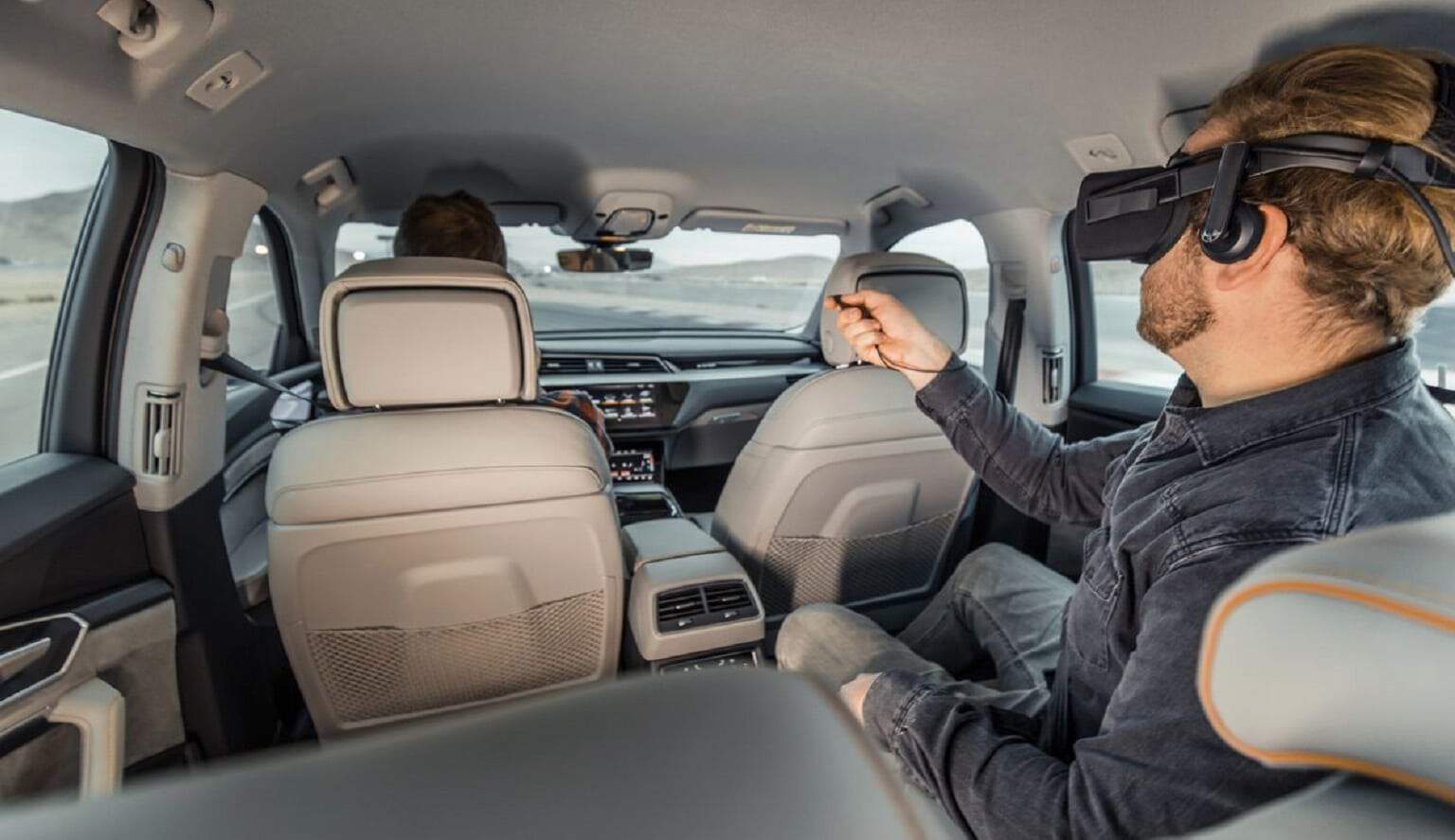 audi vr experience with person in the back seat wearing vr goggles