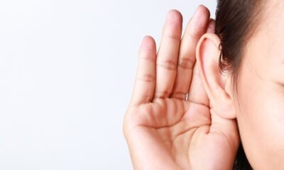 Woman holding her hand up to her ear diapason tinnitus app