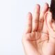 Woman holding her hand up to her ear diapason tinnitus app