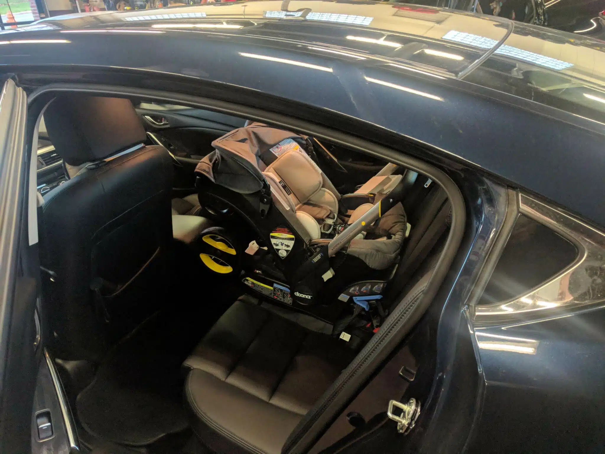 doona car seat in car backseat.