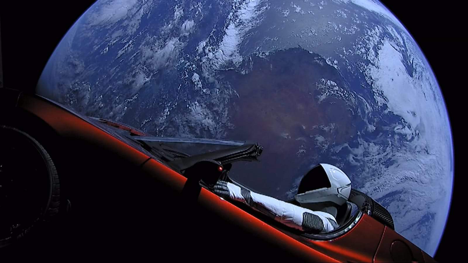 tesla in space with earth in background