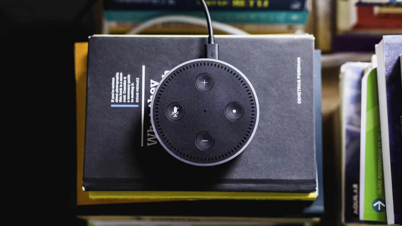 amazon echo speaker on a stack of books