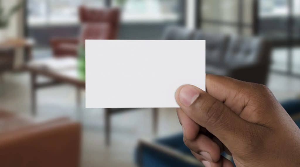 blank business card being held in front of camera