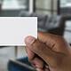 Blank business card being held in front of camera