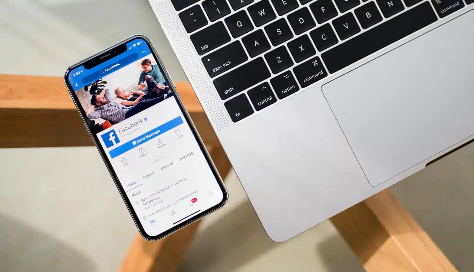 facebook tool on iphone on a table with a macbook