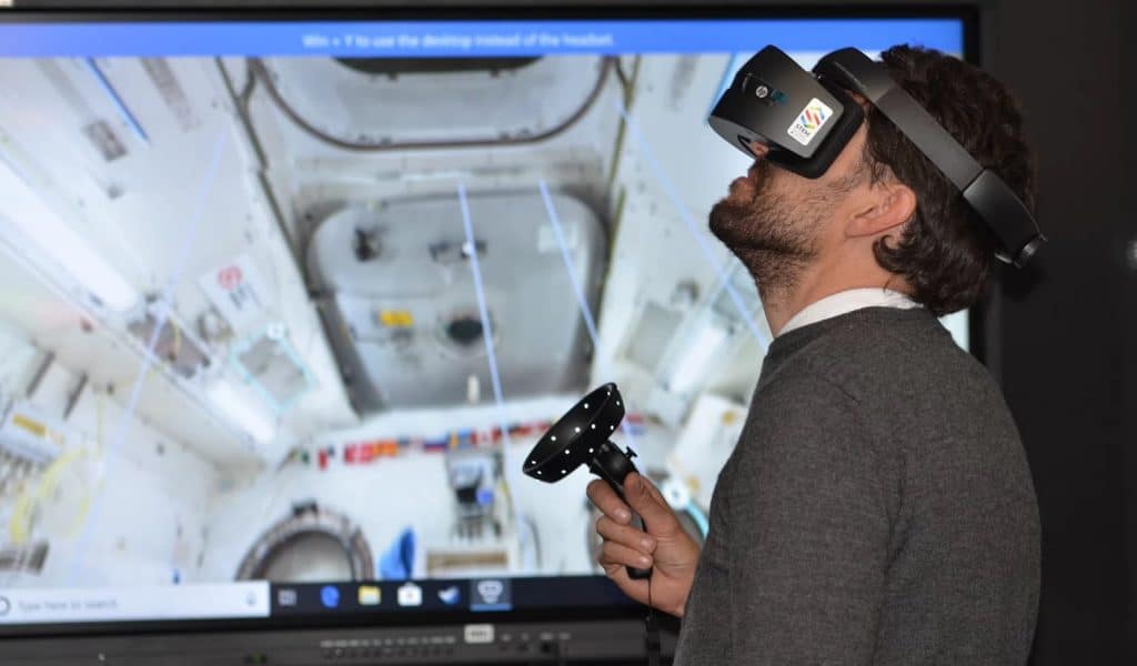 man using vr headset to explore a space ship