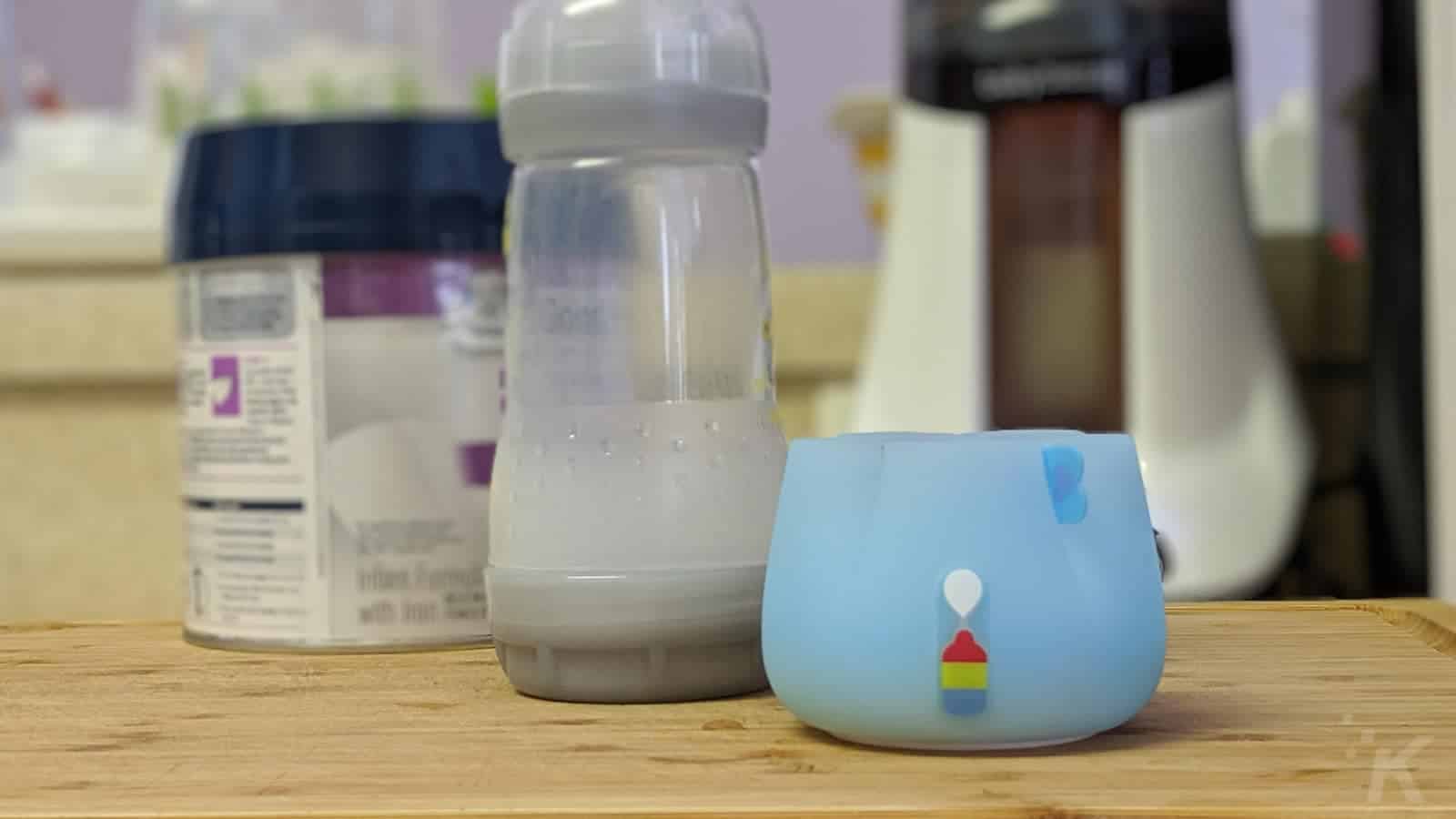 Bluesmart mia2 smart bottle sleeve with baby bottle and formula on kitchen counter