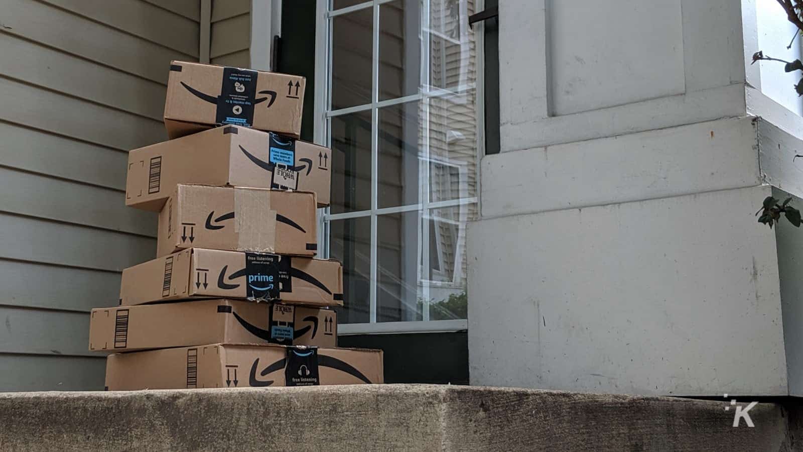 Amazon delivery boxes stacked on a porch