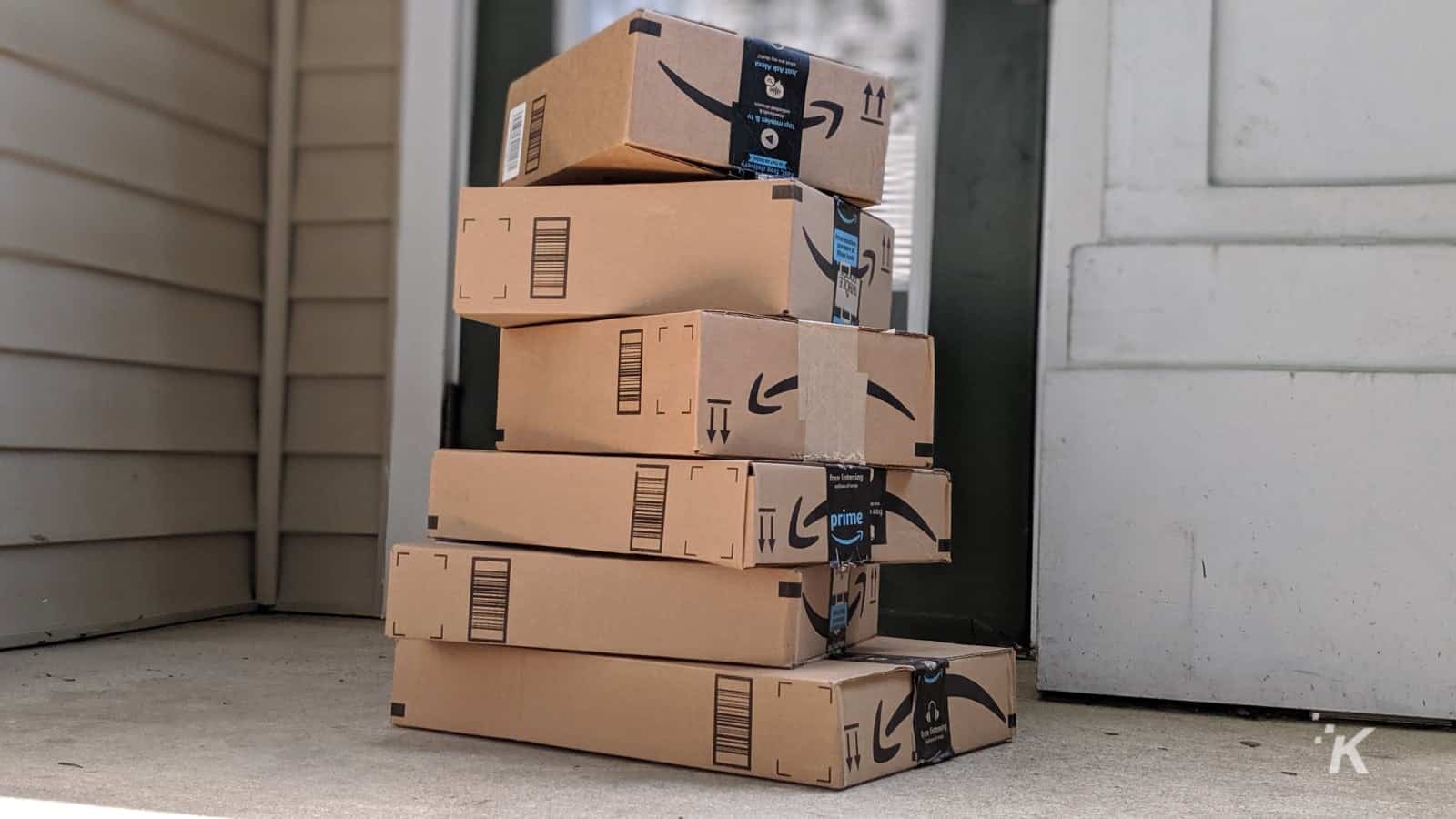 amazon delivery boxes stacked on a porch