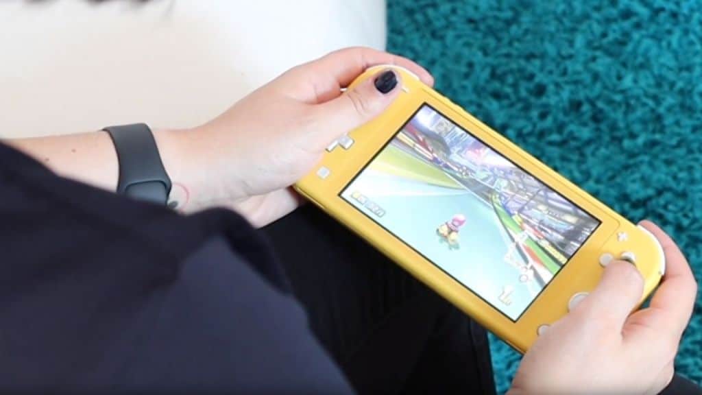 nintendo switch lite in hand