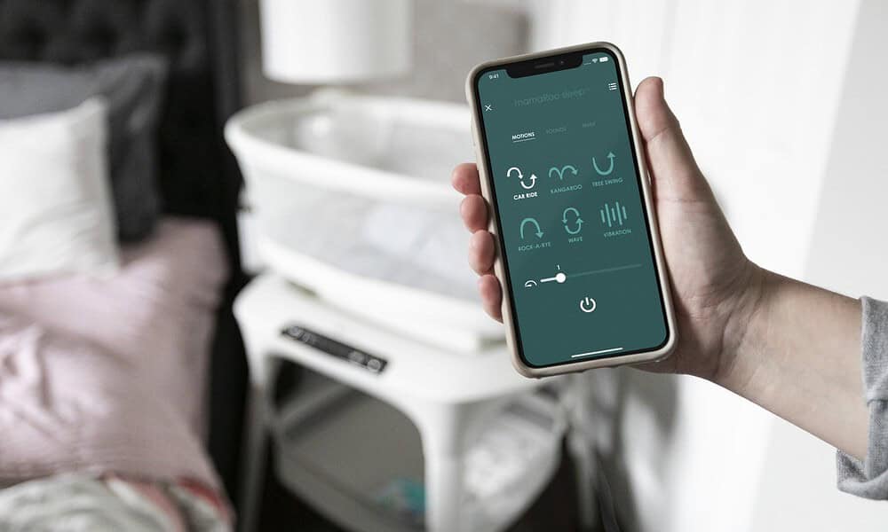 hand holding a smartphone using the mamaroo app