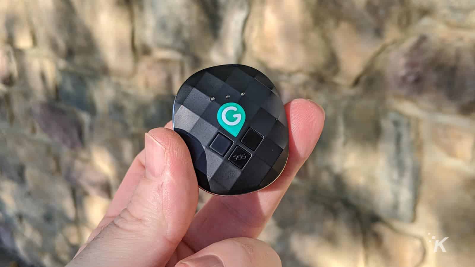 Geozilla gps tracker held in fingers