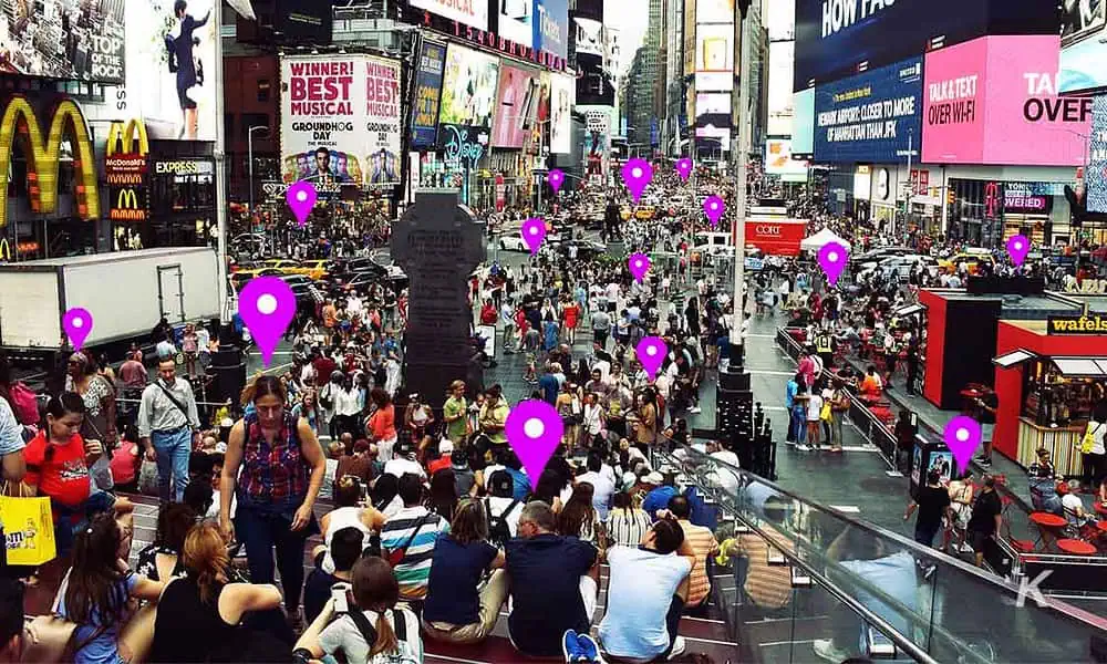 crowd of people with data points over their heads via facial recognition
