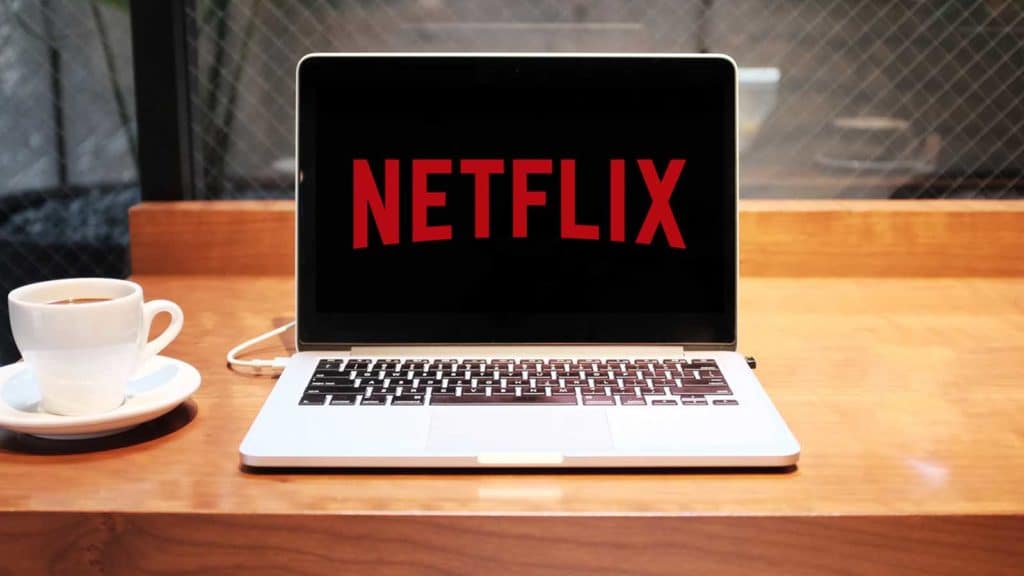 netflix on a macbook sitting on a table