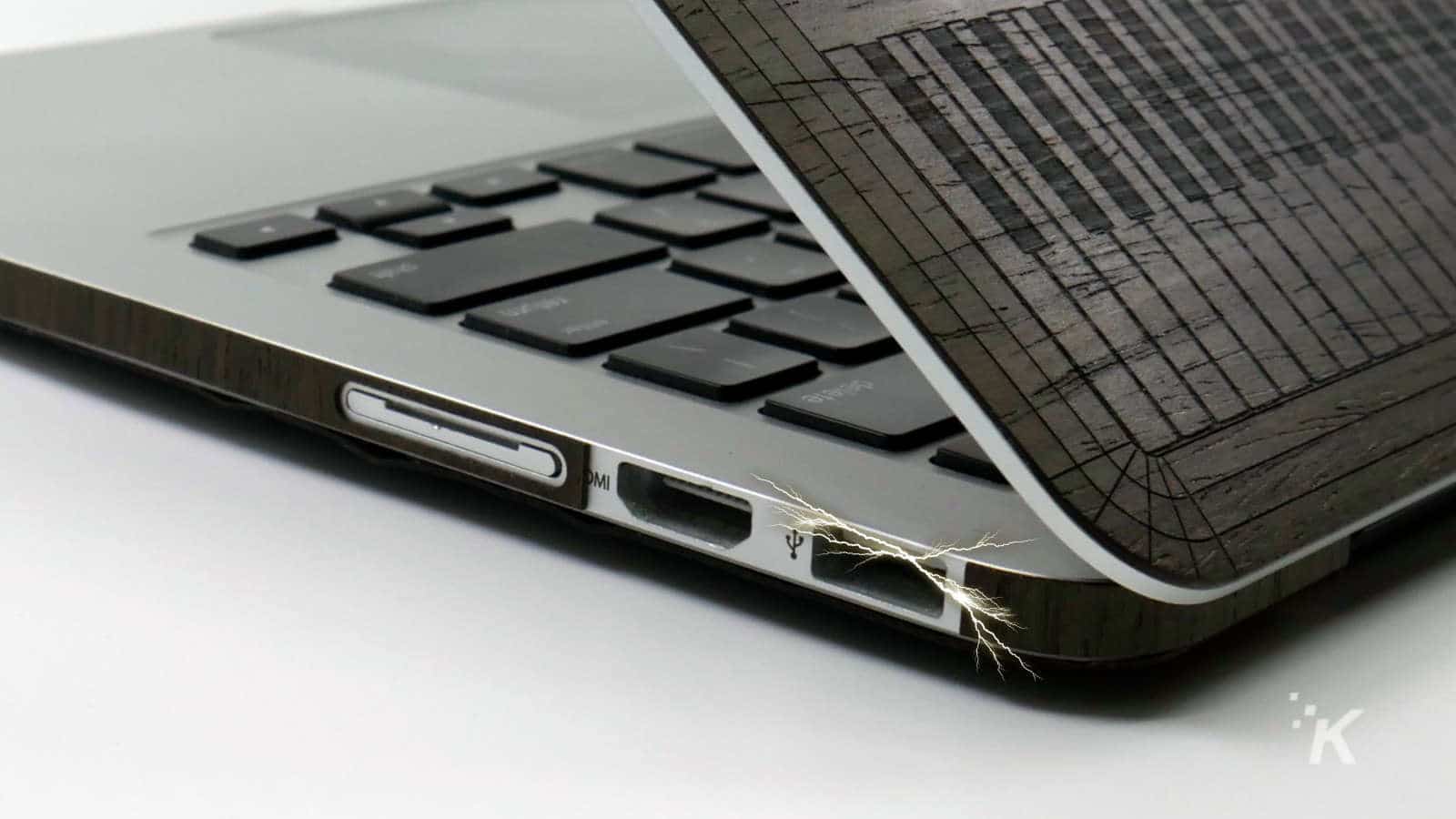 laptop usb port with electric spark coming out from it