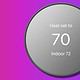 google nest thermostat on purple background