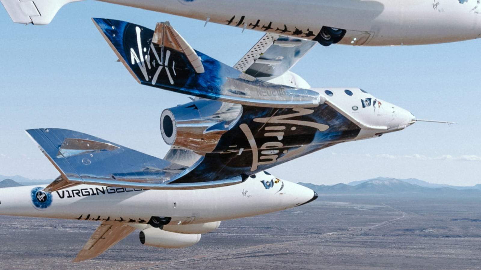 Virgin galactic vss unity spaceplane underneath its launch carrier plane