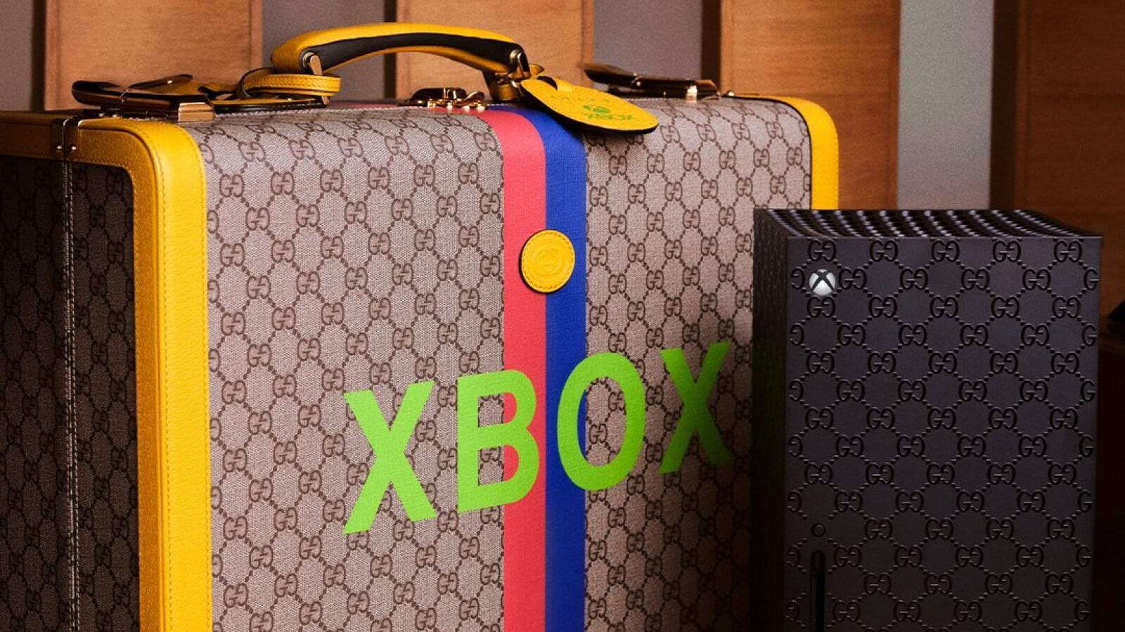 Gucci xbox series x next to gucci suitcase