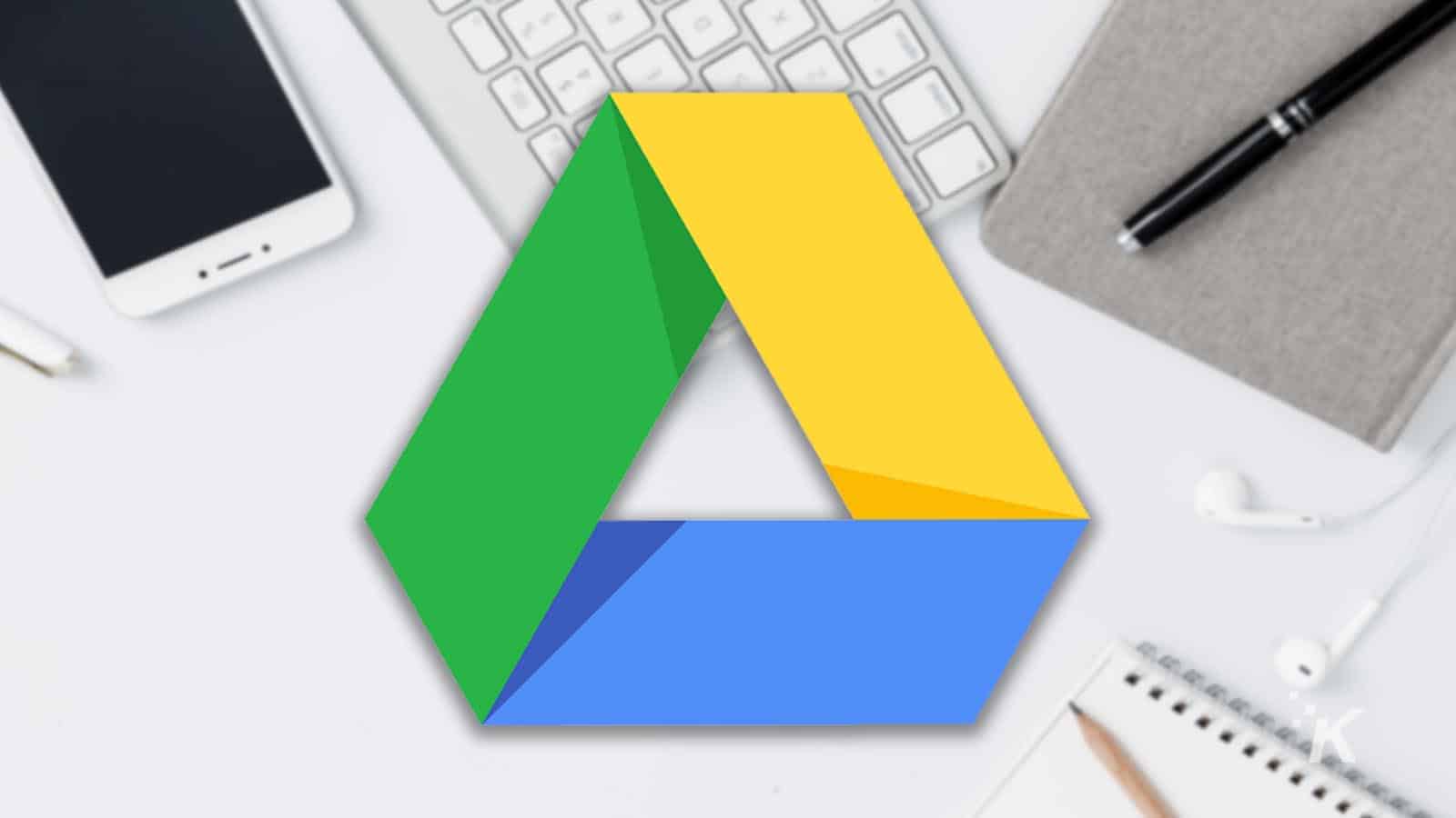 Google drive logo with blurry image of windows computer in the background