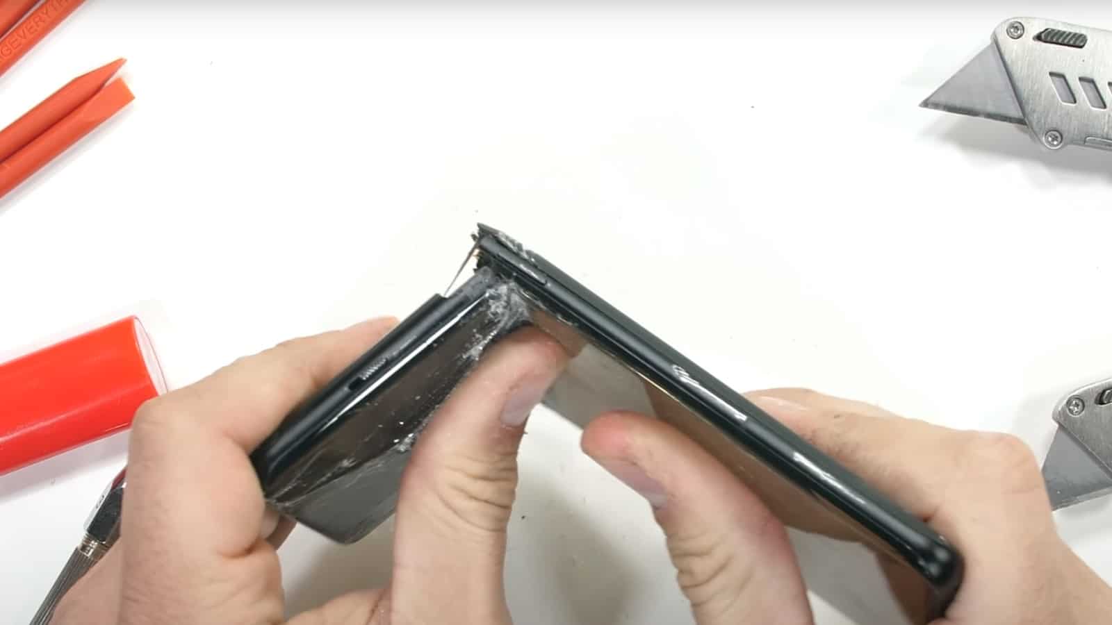 Screenshot from jerryrigeverything's teardown of the oneplus 10 pro smartphone showing the oneplus 10 pro smartphone snapped in half