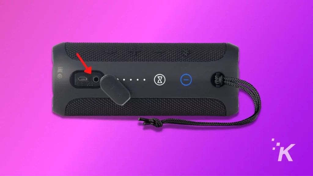 jbl bluetooth speaker highlighting aux input, on purple background