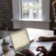 man in home office typing on a laptop cms