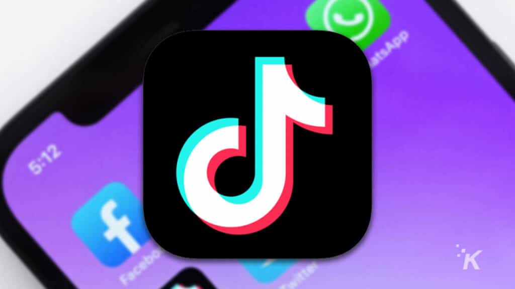 tiktok logo with blurred smartphone in the background