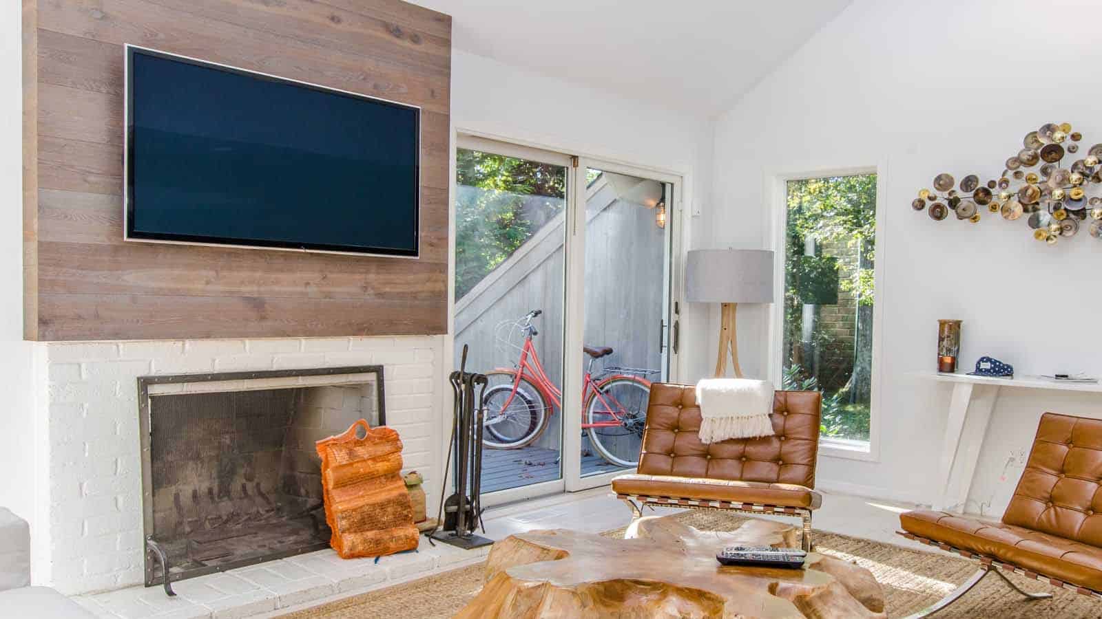 Tv mounted over fire place in cottagecore house