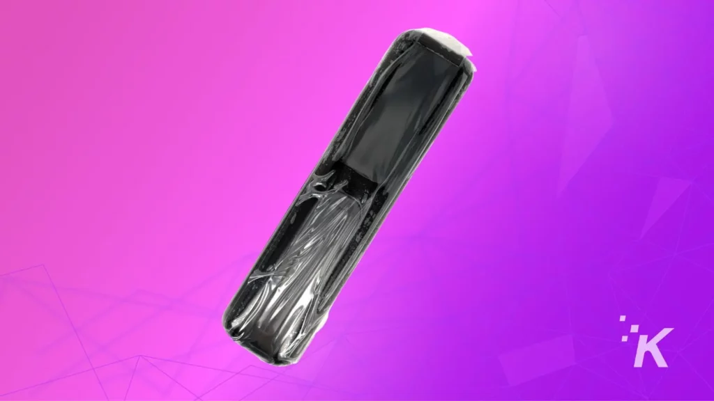 bose remote with plastic wrapping on purple background