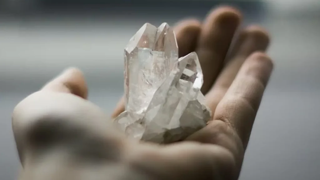 person holding a diamond in the palm of their hand