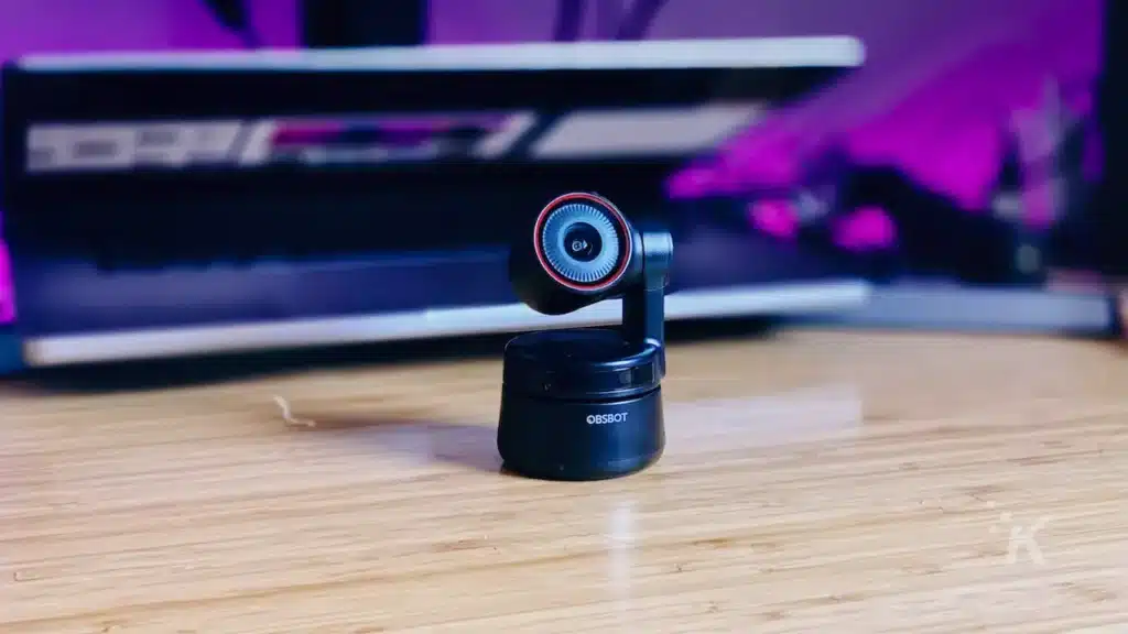 hq webcam on a desk in front of a half opened laptop