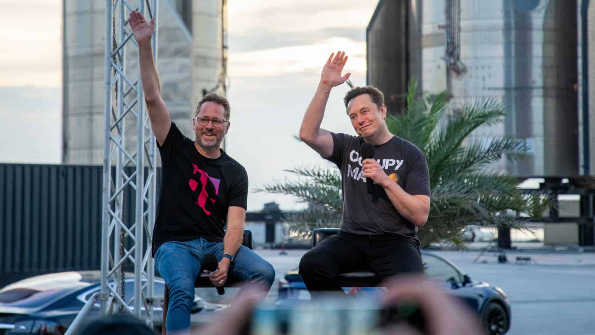 elon musk and t-mobile ceo waving