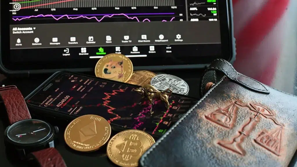 Dogecoins on top of a laptop and a wallet