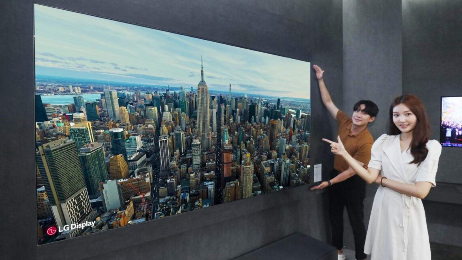 Lg 97 inch oled tv that's also a speaker, mounted on a wall