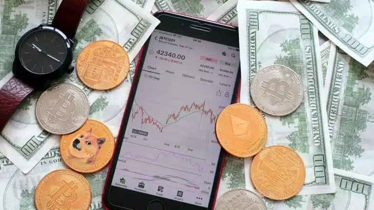 phone showing a chart and money coins bills