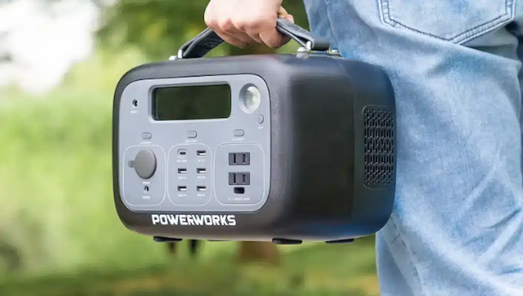 Man in jeans holding a portable powerstation