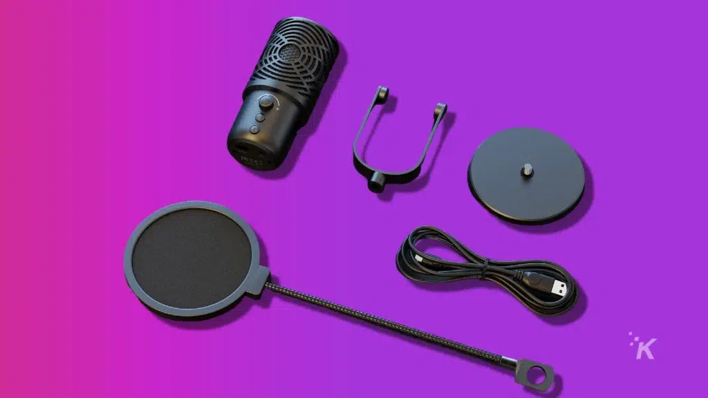 Usb microphone parts spread out over a purple background