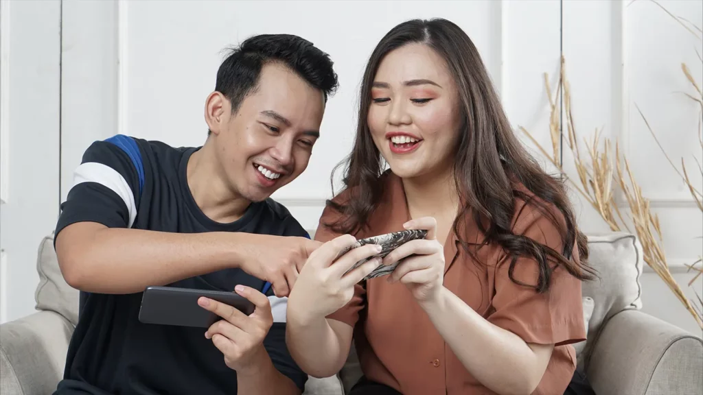 two people playing games on their phones