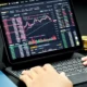 computer with charts of investing in crypto