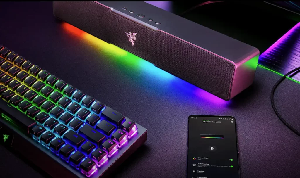 razer leviathan v2 x soundbar next to rgb chroma keyboard