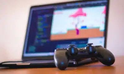 laptop on desk with a video game controller