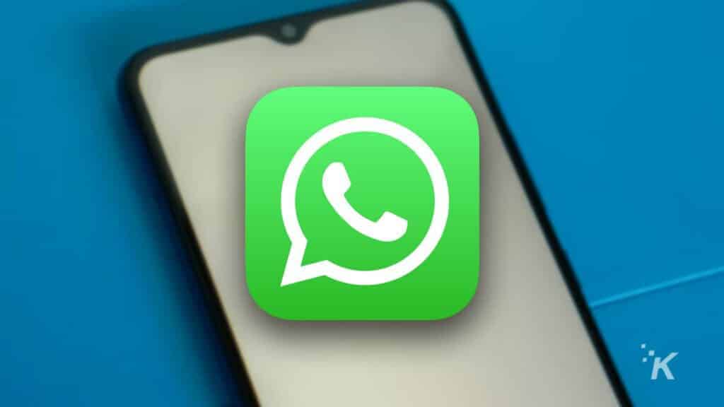 WhatsApp icon on blurred smartphone background