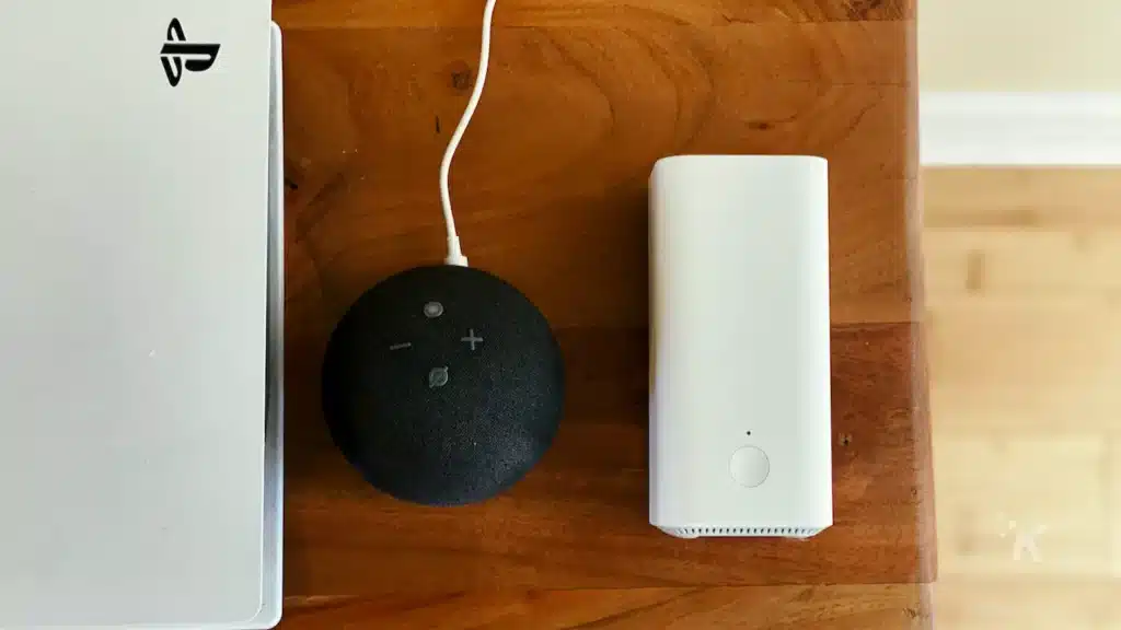 wifi mesh router next to echo dot and sony ps5