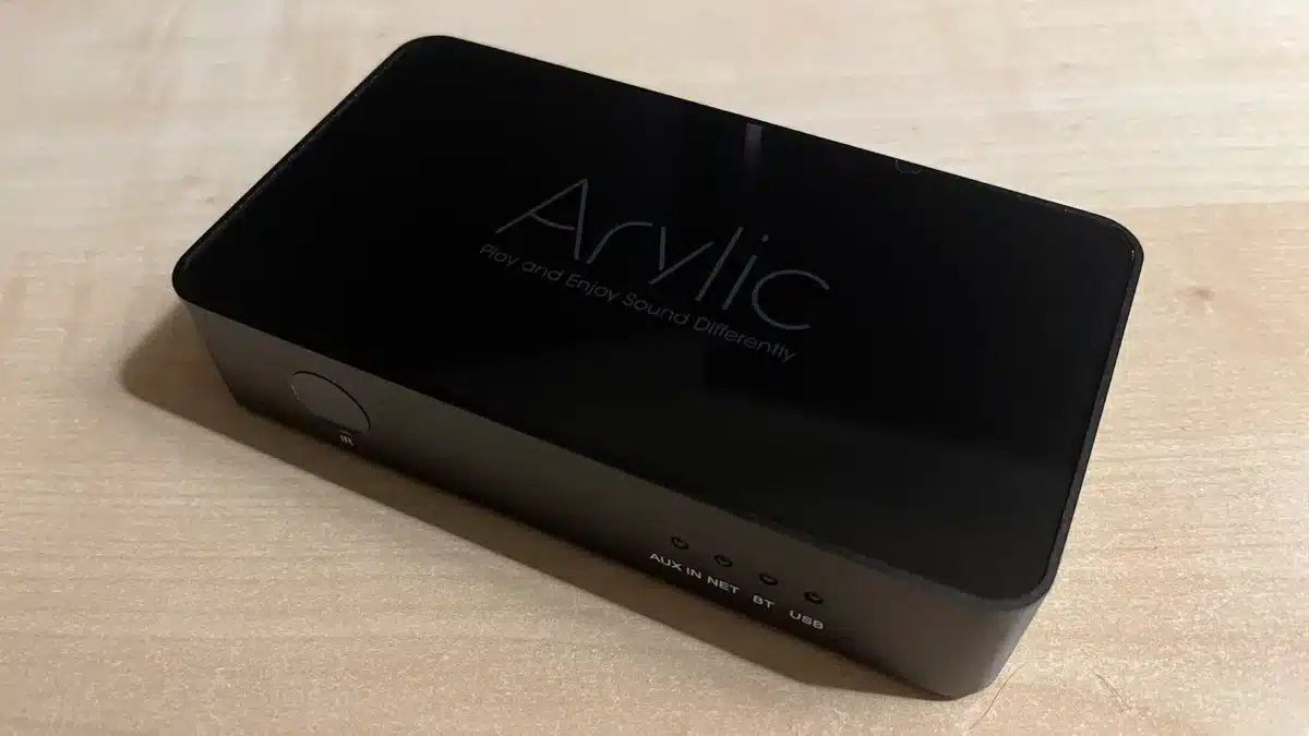 Arylic wireless streaming pre-amp on wooden table